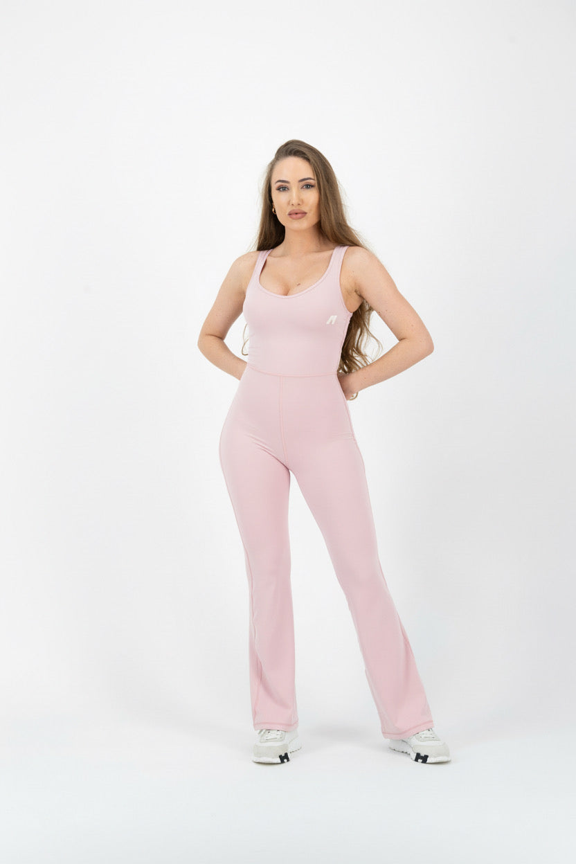 Woman wearing a pink jumpsuit on a white background