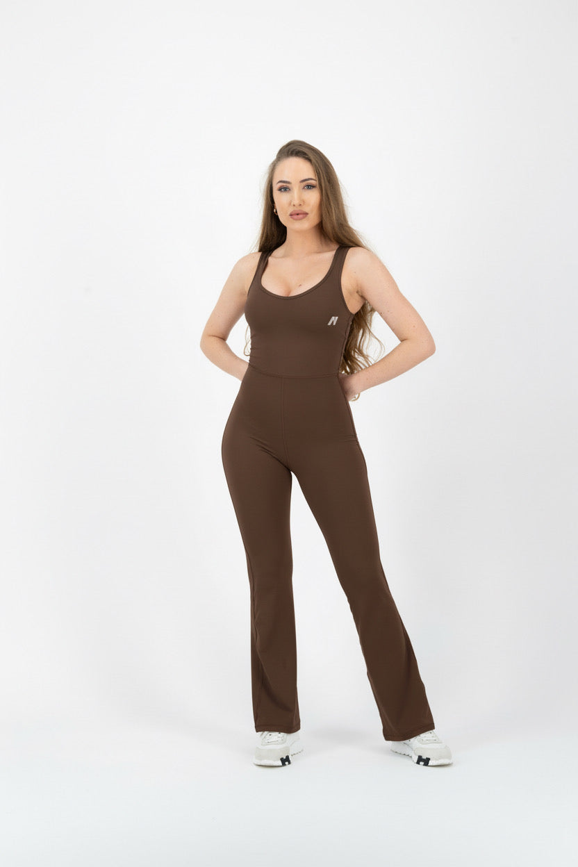 Woman wearing a brown jumpsuit on a white background